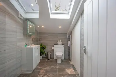a bathroom with a toilet and a sink at Mandarin Premier Apartments B - Loft studio apt in Oban