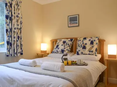 a bedroom with a bed with towels on it at Tigh An Aighear in Arduaine