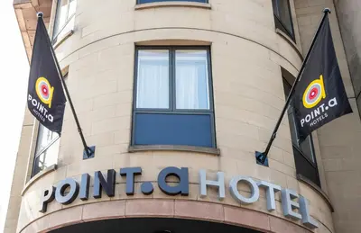 a building with two flags on top of it at Point A Hotel Edinburgh Haymarket in Edinburgh