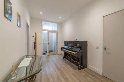 a hallway with a piano in a room at Haymarket Spacious 3 Bedroom Street Level in Edinburgh