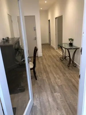 a living room with a table and a glass table at Haymarket Spacious 3 Bedroom Street Level in Edinburgh