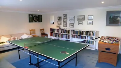 a living room with a ping pong table at Arndean Cottages in Dollar