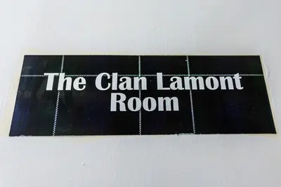 a sign that reads the clam lawn room at Beach Front Flat, Brodick in Brodick