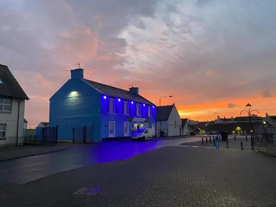 a building with blue lights on the side of it at Marina View Guest House in Irvine