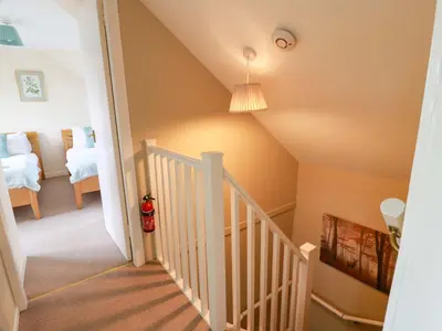 a staircase leading to a bedroom in a house at Cairnhill in Girvan