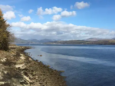 a large body of water with mountains in the background at Pier View in Dunoon