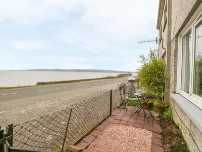 a view of the ocean from the balcony of a house at Pier View in Dunoon