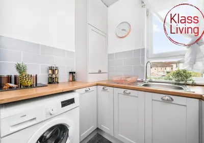 a kitchen with a washing machine and a sink at Anderson Apartment by Klass Living Motherwell in Motherwell