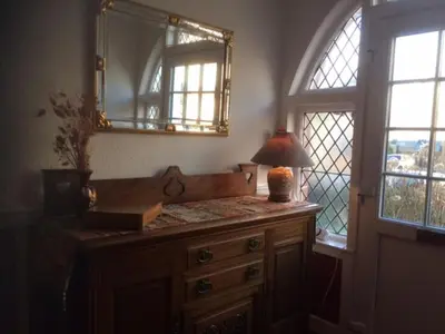 a bathroom with a vanity with a mirror and a lamp at Haven House in Largs