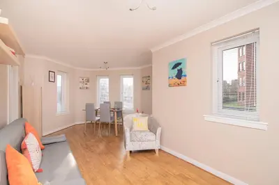 a living room with a couch and a table at The Cluthar - Ground Floor West End City Centre Rockvilla flat & Parking in Glasgow