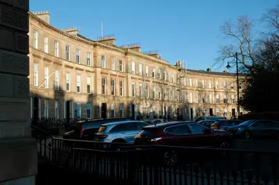 a large building with cars parked in front of it at The Cluthar - Ground Floor West End City Centre Rockvilla flat & Parking in Glasgow