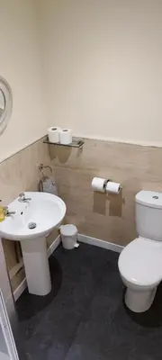 a bathroom with a white toilet and a sink at Cala Sith Guesthouse in Port Ellen