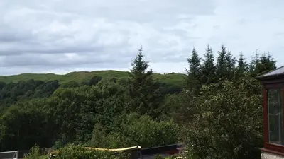a view of a mountain with trees in the background at Skerryvore in Oban