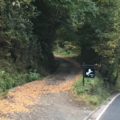 a road with a sign on the side of it at Whiteley’s Cottages studio in Dumbarton