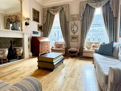a living room with a couch and a fireplace at Frederick Street - stylish apartment in the heart of New Town! in Edinburgh