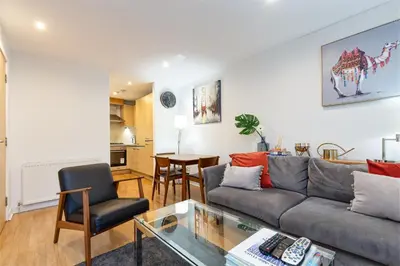 a living room with a couch and a table at Modern 2 bed BroomPark/Central apt. with Parking in Glasgow