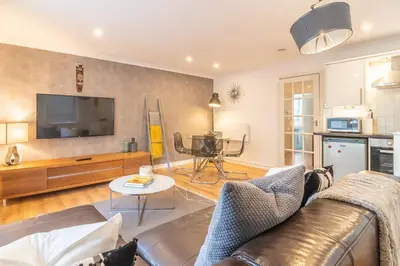a living room with a couch and a tv at Merchant City Glasgow Green Apartment With Parking in Glasgow