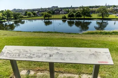 a park bench in front of a lake at 5 star beautiful & vintage, spacious apt in chic location! in Edinburgh