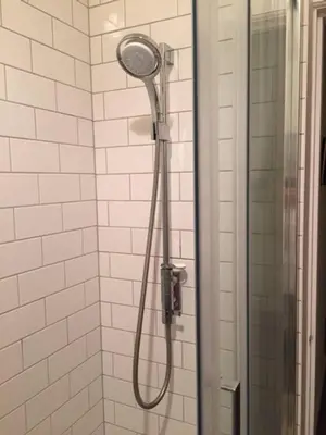 a shower with a shower head in a bathroom at 5 star beautiful & vintage, spacious apt in chic location! in Edinburgh