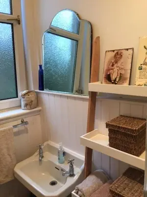 a bathroom with a sink and a mirror at 5 star beautiful & vintage, spacious apt in chic location! in Edinburgh