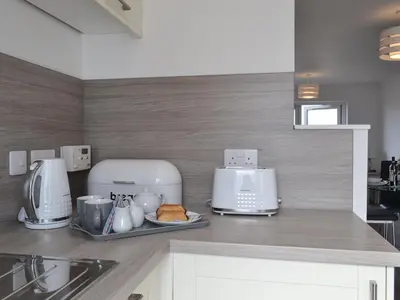 a kitchen with white appliances on a counter at Sealladh Alainn in Oban