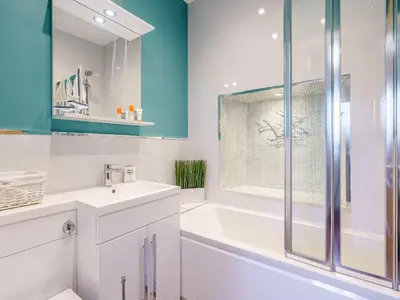 a bathroom with a tub and a sink and a shower at Ivy Cottage in Dunoon