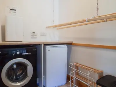 a laundry room with a washer and a washing machine at Lismore Cottage in North Ballachulish