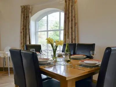 a dining room table with chairs and a table and a window at Horsemill - Uk10794 in Ballingry
