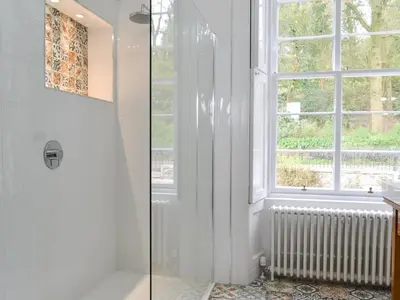 a bathroom with a shower and a window at Fircliff - The House On Bute in Port Bannatyne