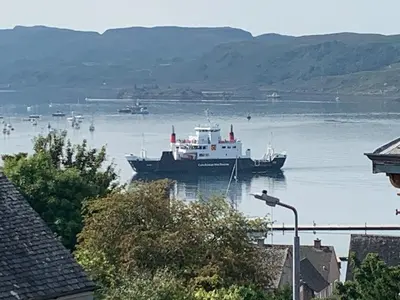 a large boat in a large body of water at Finlaggan Apartment in Oban