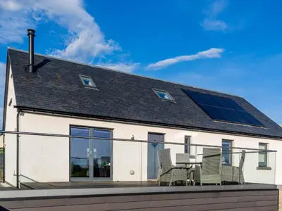 a house with a solar system on the roof at Thistlebank in Banknock
