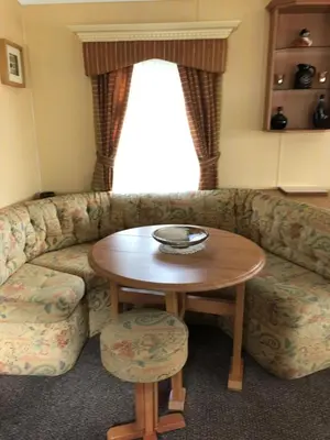 a living room with a couch and a table at 40 Glenfinart Caravan Park in Dunoon