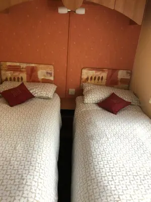 two beds sitting next to each other in a room at 40 Glenfinart Caravan Park in Dunoon