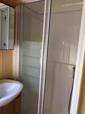 a bathroom with a shower and a sink at 40 Glenfinart Caravan Park in Dunoon