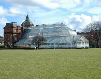 a large glass greenhouse in front of a building at The Socair - Bright Contemporary Merchant City Flat in Central Location in Glasgow