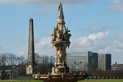 a monument in a park in front of a building at The Socair - Bright Contemporary Merchant City Flat in Central Location in Glasgow