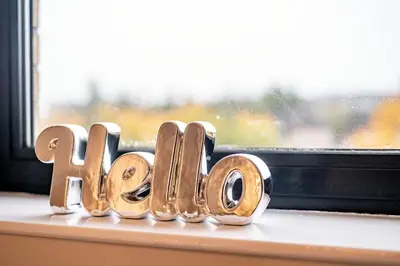 a wooden block spelling out the word love sitting on a window at ArcView - SEC Hydro Two Bed Flat With Free parking and Great View in Glasgow