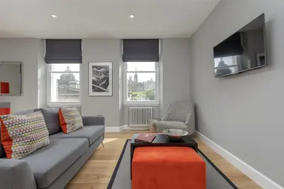 a living room with a couch and a table at Destiny Scotland Hanover Apartments in Edinburgh