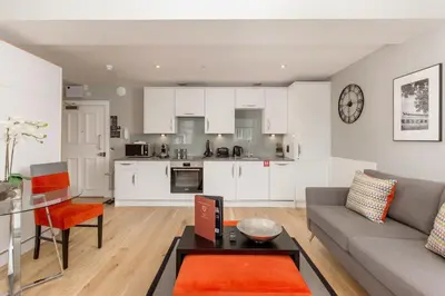 a living room with a couch and a table at Destiny Scotland Hanover Apartments in Edinburgh