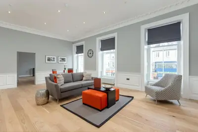 a living room with a couch and a chair at Destiny Scotland Hanover Apartments in Edinburgh