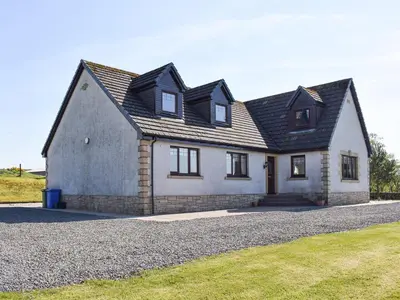 a large white house with a black roof at Lawford Lodge in Bonnybridge