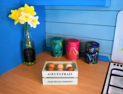 a box of eggs on a table with a vase of flowers at Glen Bay - 2 Bed Lodge on Friendly Farm Stay with Private Hot Tub in New Cumnock