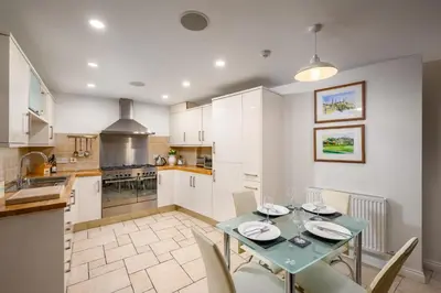a dining room with a table and chairs in a kitchen at Stylish & Central 2BR Stockbridge Gem in Edinburgh