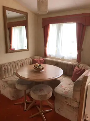 a living room with a table and a couch at Bermuda 29 in Dunoon