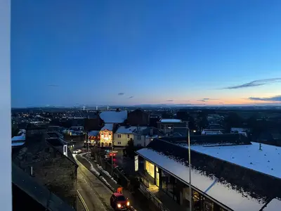 a view of a city at night with snow at Carvetii - Edward House D - 2 Dbl bed 2nd floor flat in Dunfermline