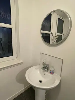 a white bathroom with a sink and a mirror at Carvetii - Edward House D - 2 Dbl bed 2nd floor flat in Dunfermline