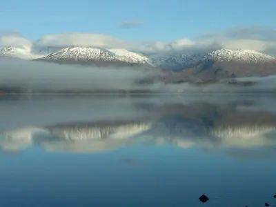 a view of a lake with snow covered mountains at Argyllholidaycottage Loch Awe in Eredine