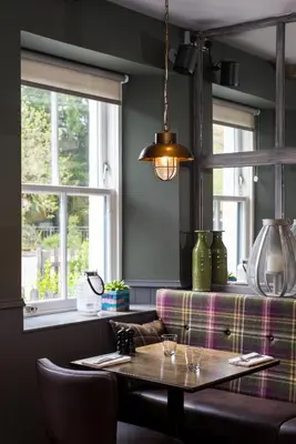 a dining room with a table and a couch at The Kilchrenan Inn in Oban