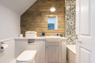 a bathroom with a sink and a toilet and a mirror at The Kilchrenan Inn in Oban