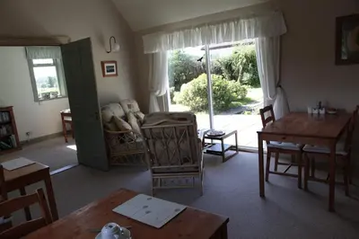 a living room with a table and chairs and a window at Dunchraigaig House in Kilmartin
